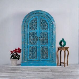 Handcrafted distressed blue carved wooden wardrobe cabinet with arched doors – front view.
