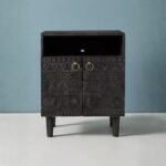 Handcrafted mango wood bedside cabinet with tribal carved design and antique brass handles