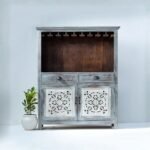 Handcrafted distressed grey wooden bar cabinet with carved white door, glass hanger rack, drawers, and wine bottle storage – 90 × 40 × 130 cm