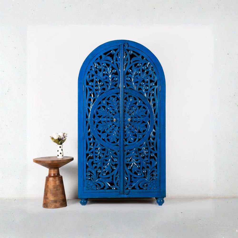 Royal blue hand-carved wooden wardrobe cabinet with arched doors – front view.