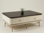 Modern fluted coffee table with black top, ribbed drawers and gold metal base
