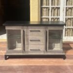 Vintage distressed wooden sideboard with glass doors and central drawers