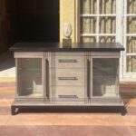 rustic buffet cabinet with black top and display storage for dining or living room