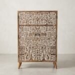 Hand-carved wooden cabinet with tribal art motifs