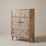 Hand-carved wooden cabinet with tribal art motifs