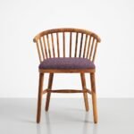 Solid wood dining chair with spindle back and upholstered seat in natural finish