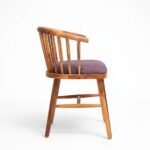 Solid wood dining chair with spindle back and upholstered seat in natural finish