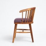 Solid wood dining chair with spindle back and upholstered seat in natural finish